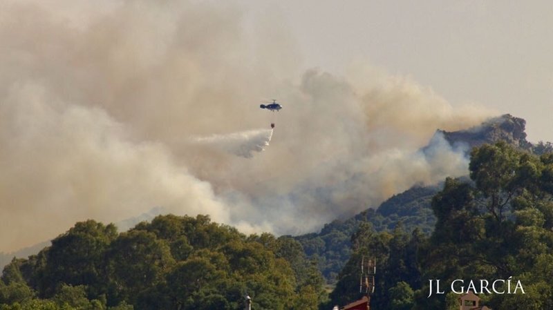 Un helicoptero trata de frenar el fuego en El Bujeo