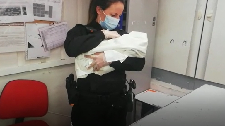 Una agente con el beb&eacute; en brazos