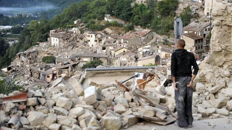 A survivor looks at the collapsed buildings of the town of Pescara del Tronto  Italy  after an earthquake  Wednesday  Aug  24  2016   The magnitude 6 quake struck at 3 36 a m   0136 GMT  and was felt across a broad swath of central Italy  including Rome where residents of the capital felt a long swaying followed by aftershocks   Cristiano Chiodi ANSA via AP 